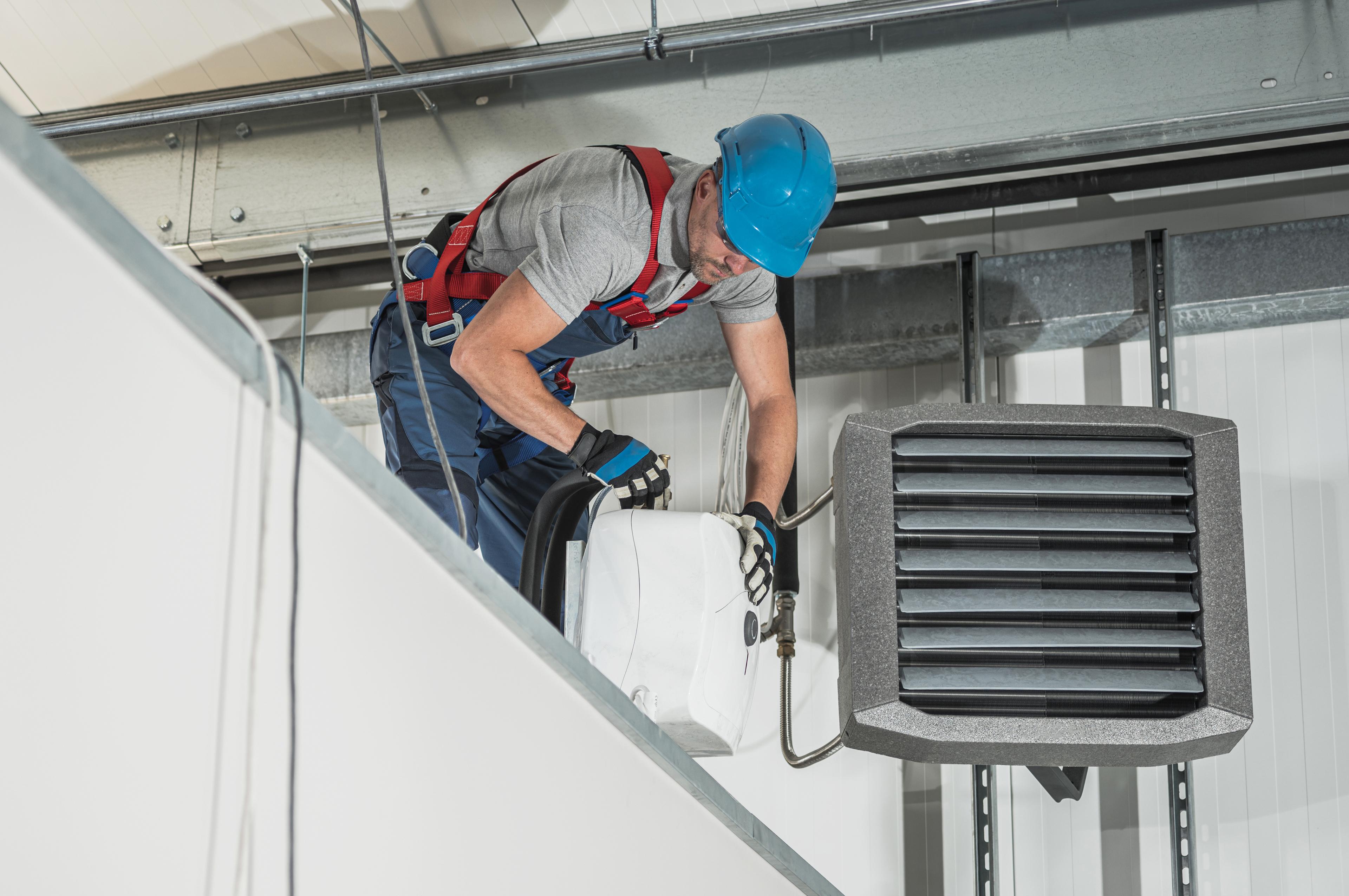 hvac-technician-installing-new-warehouse-air-water-heaters